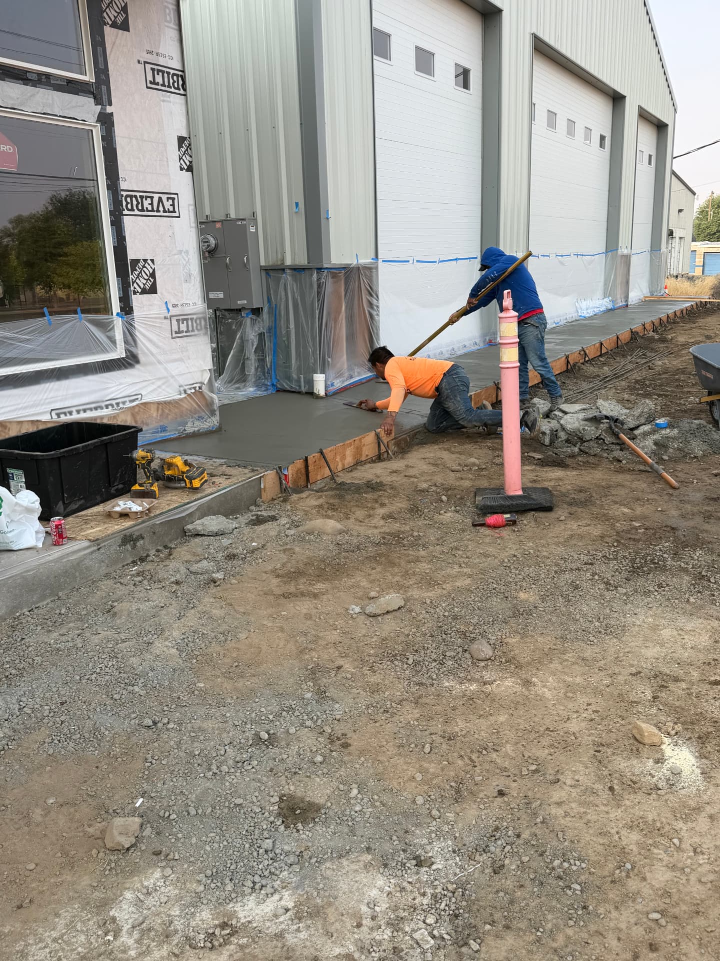 Piña's Roofing crew working alongside a fully masked and protected commercial building exterior