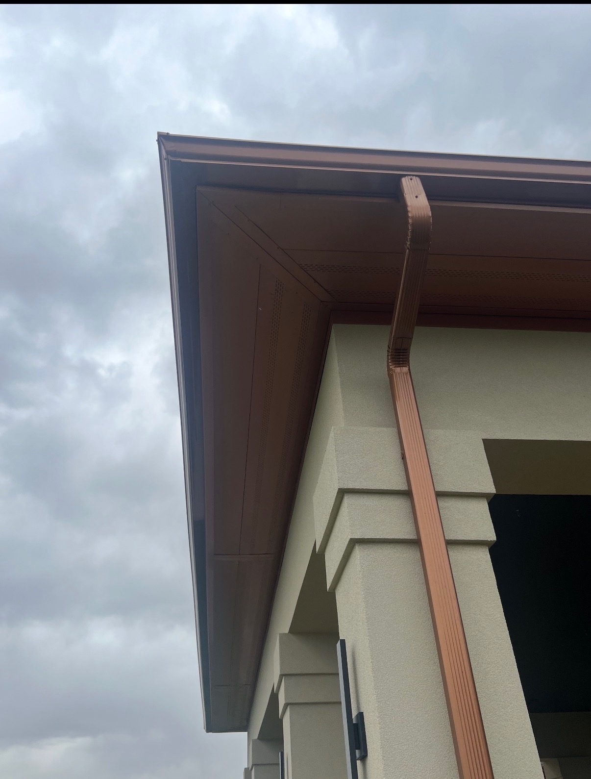 Custom copper downspout and seamless gutter corner detail
