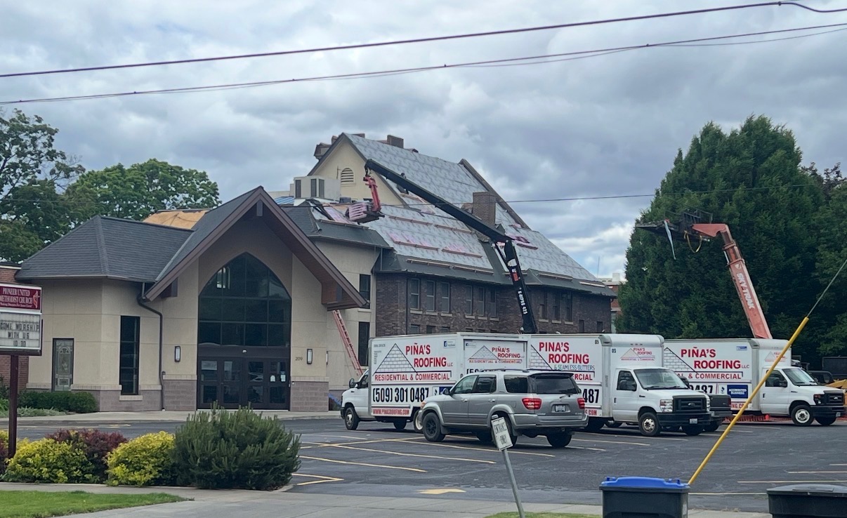 Pina's Roofing crew installing shingles on a residential roof in Walla Walla