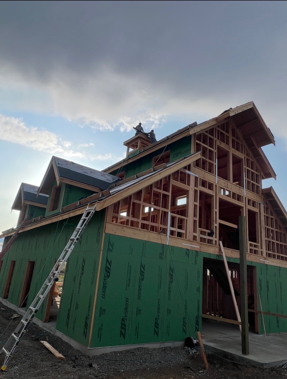 Large custom timber-framed home in progress with new roof underlayment