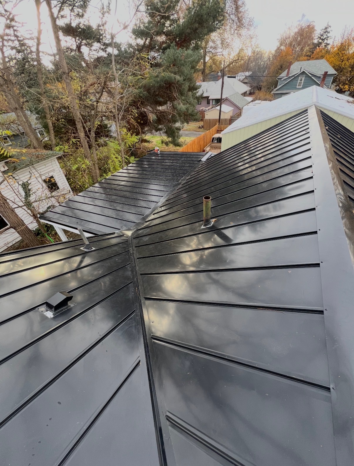 Finished black standing seam metal roof installed by Pina's Roofing