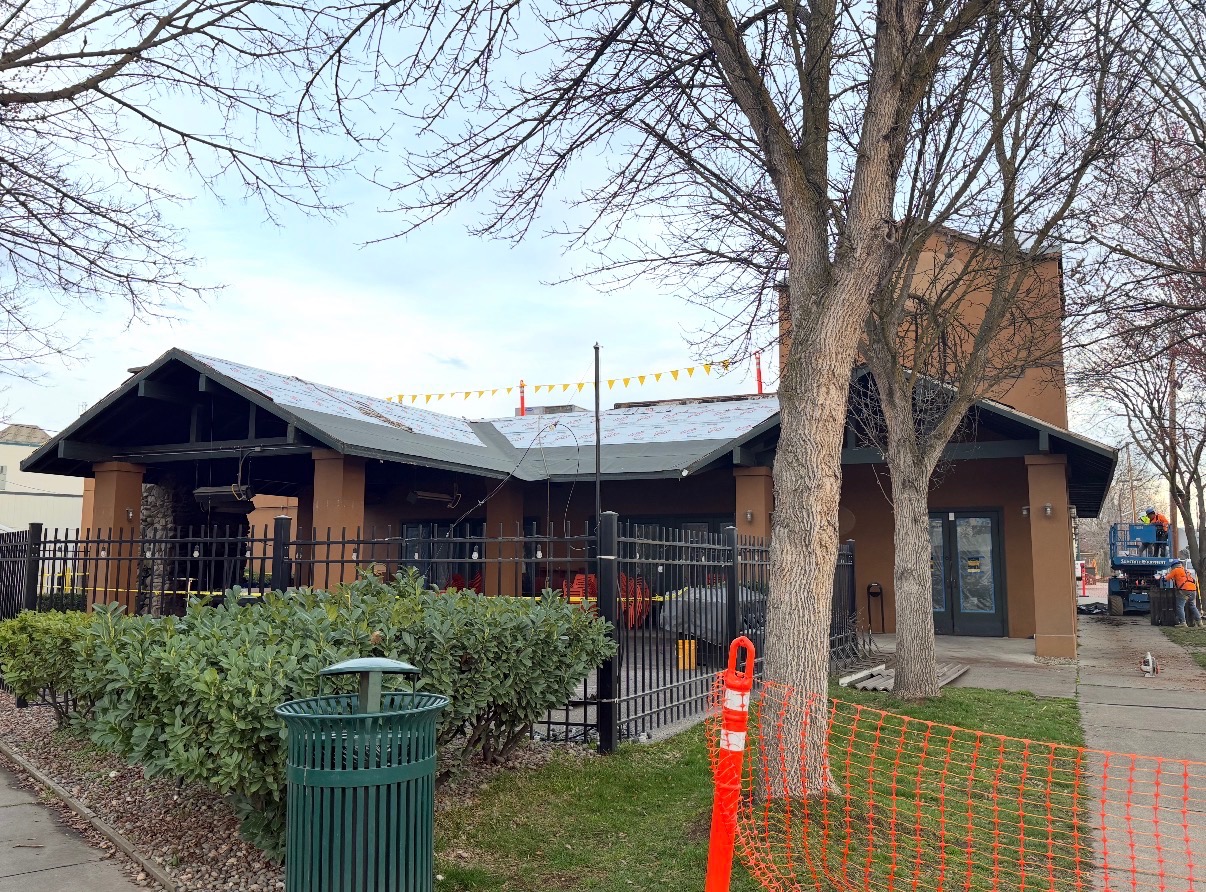 Commercial building roof tear-off and re-roof in progress